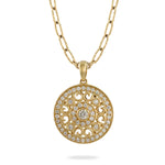Load image into Gallery viewer, A gold pendant necklace featuring an intricate circular filigree design set with small clear stones, suspended from a delicate gold chain against a plain white background.
